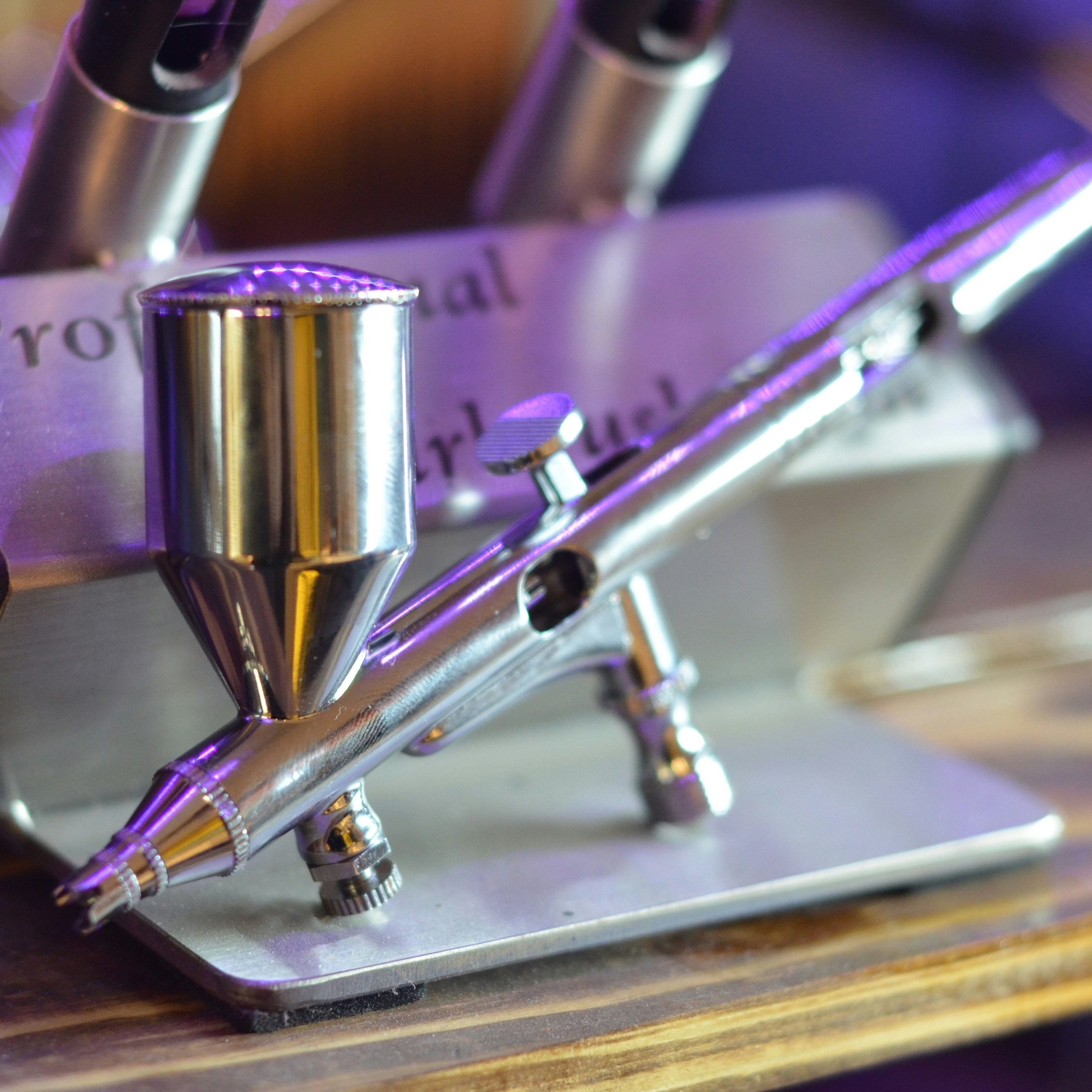 black scissors near brown pencils on top of white textile